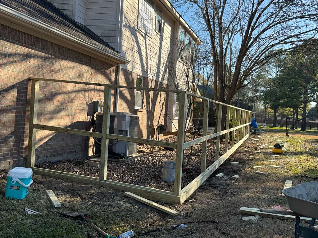 Fence contractor completing a residential installation in the Houston area